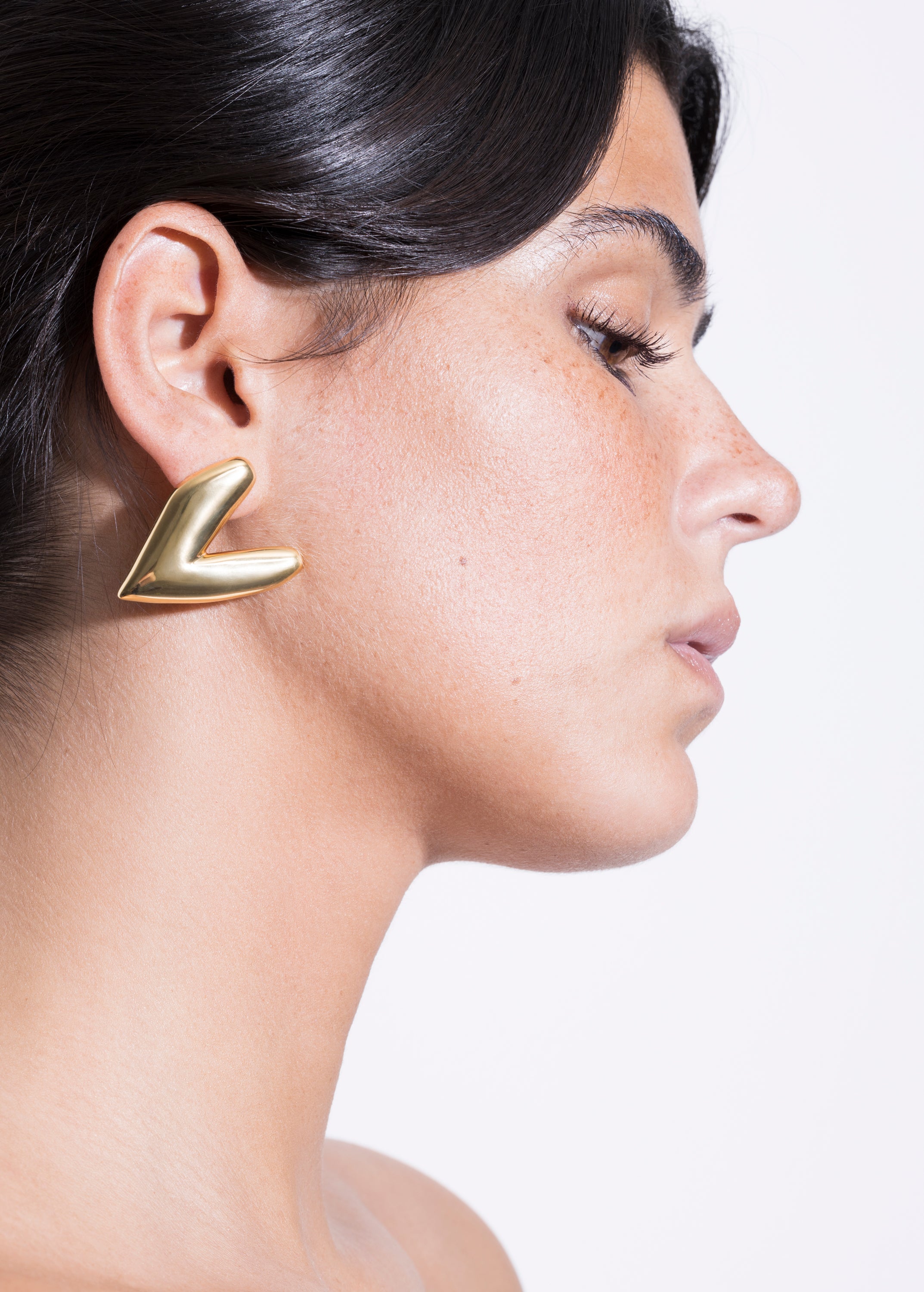 model wearing kokoro earrings in gold