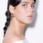 model wearing kokoro earrings in gold