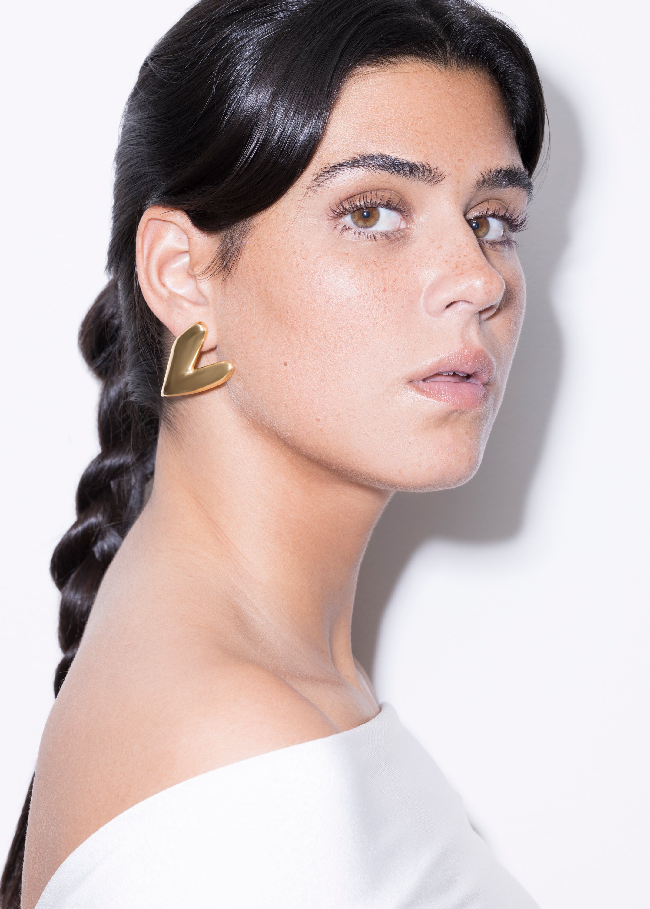 model wearing kokoro earrings in gold