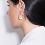 model wearing léa earrings in gold