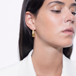model wearing léa earrings in gold