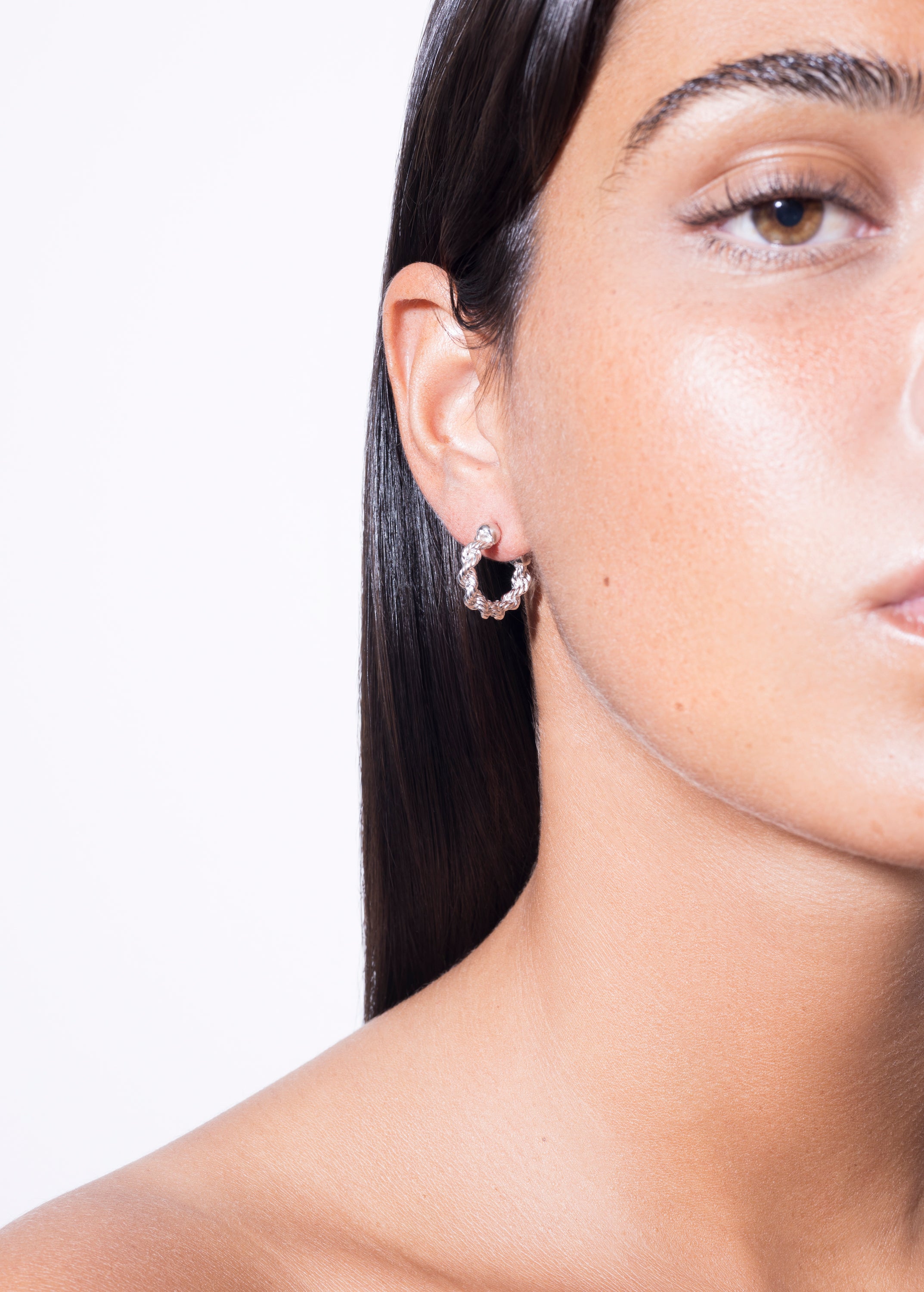 model wearing mini bia earrings in silver