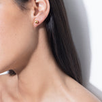model wearing mini sade earrings in gold
