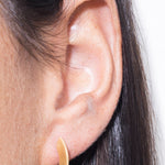 model wearing sarah mini earrings in gold