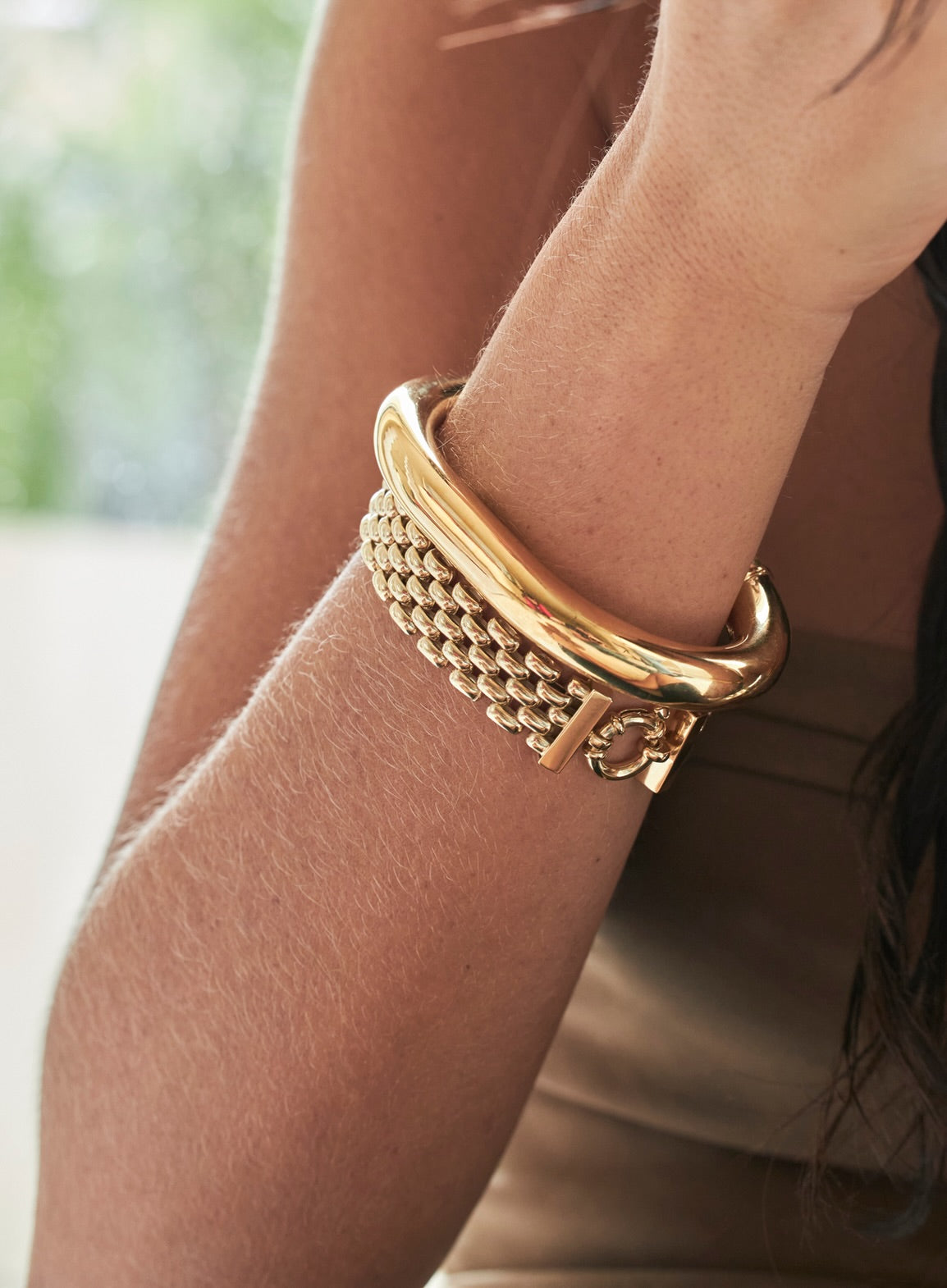 Gold jewelry allergy causes discomfort; elegant gold bracelet on wrist.