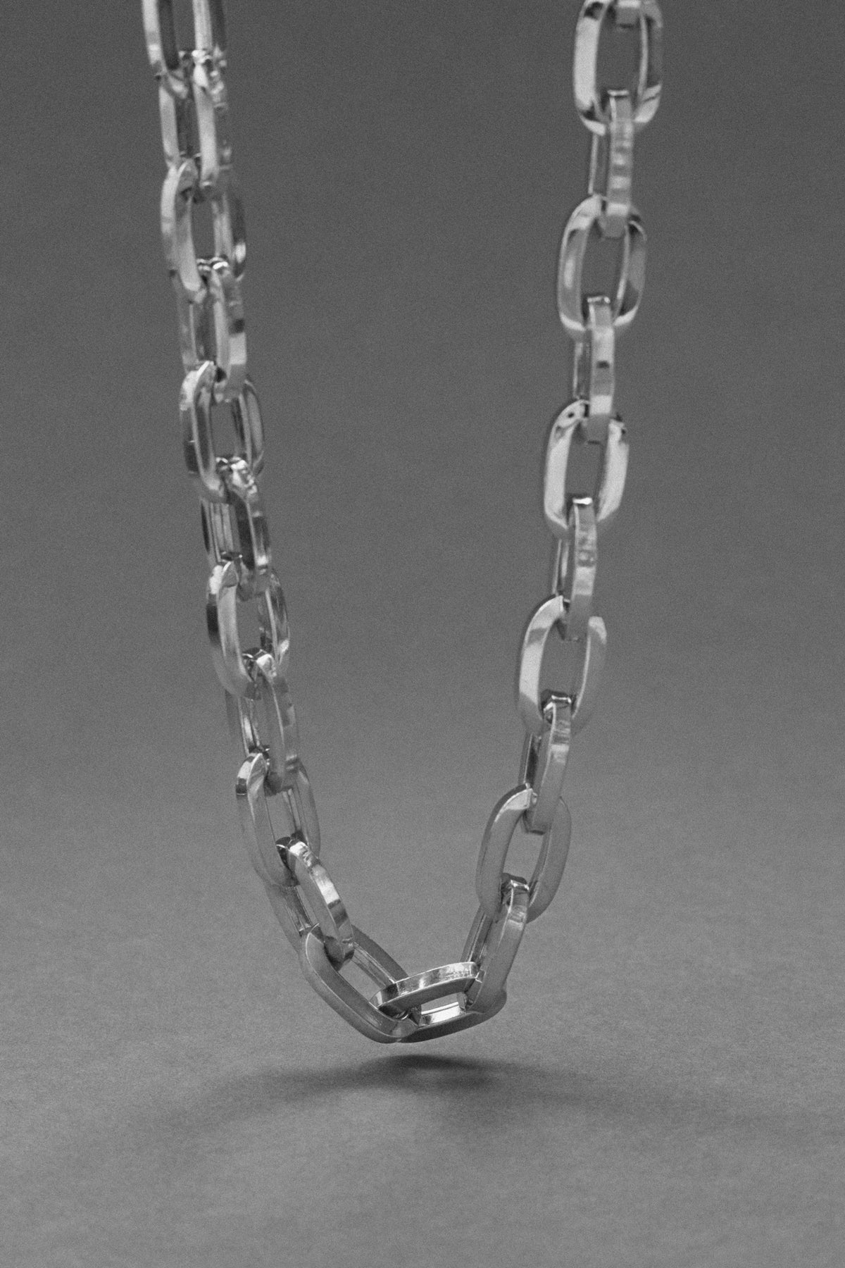 Close-up of a silver necklace made from 925 sterling silver, showcasing an elegant link design.