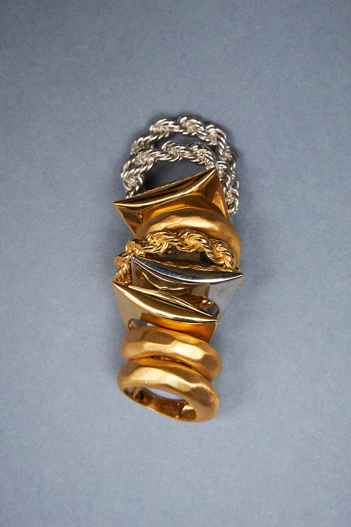Stackable 925 sterling silver rings in a sculptural design with gold and silver hues.