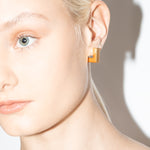 model wearing eliza earrings in gold