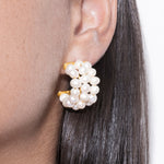 filomena earrings worn by a person with dark hair.