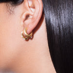 model wearing mini sara earrings and norma earrings white in gold